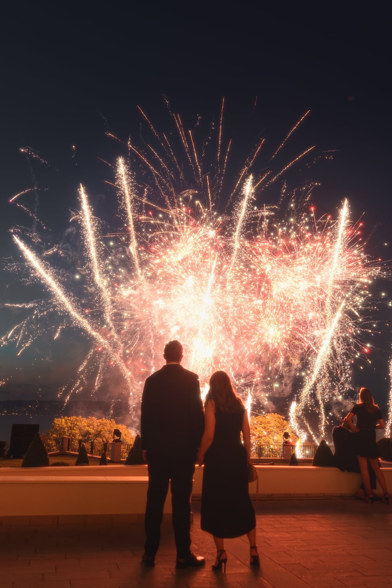 A couple watching the fireworks from the terrace