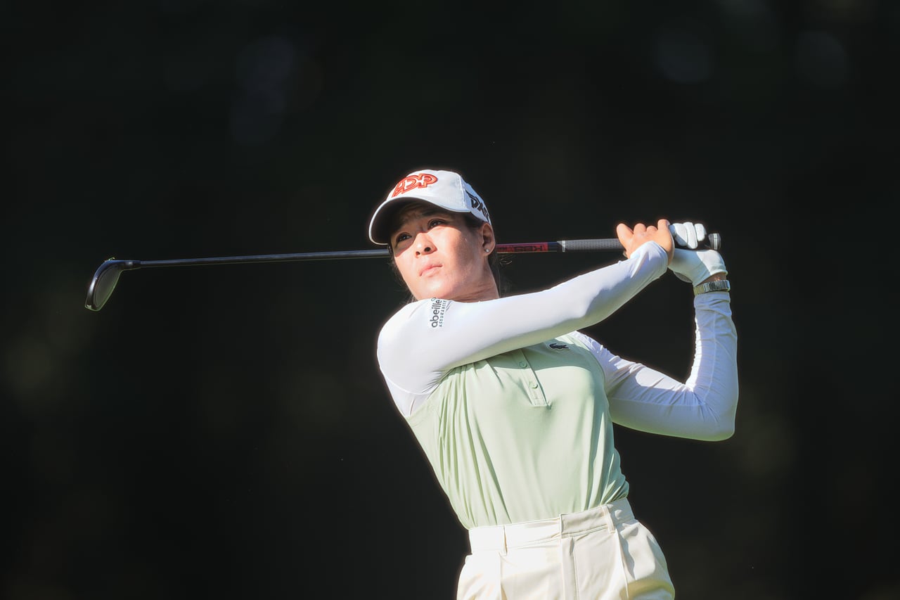 A player finishing her swing
